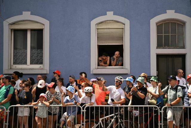 Spectators line the race route at the start of the 14th stage of the 113th edition of the Tour de France cycling race, 155,3 km between Mulhouse and Le Markstein in the Vosges mountains, on July 18, 2026. (Photo by Jeff PACHOUD / AFP)