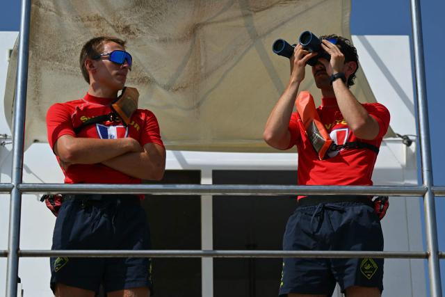 Lifeguards monitor the beach from their observation tower at Le Racou beach in Argeles-sur-Mer, on the Mediterranean coast in southwestern France, on July 18, 2026. (Photo by Lionel BONAVENTURE / AFP)