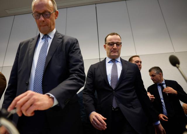 (FILES) (L-R) German Chancellor and leader of Germany's Christian Democratic Union (CDU) Friedrich Merz, and the parliamentary group leader of the conservative Christian Democratic Union (CDU) Jens Spahn take their seats at the start of a parliamentary group meeting of the conservative party union on December 2, 2025 in Berlin, Germany. Jens Spahn, a prominent figure in German Chancellor Friedrich Merz's centre-right party resigned his leadership post on July 18, 2026, party sources told AFP, amid controversy over his use of a surrogate mother in the US despite a ban on the practice in Germany. "In recent days, I have come to realise that my personal happiness in starting a family with my husband and becoming a father is incompatible with my political office," Jens Spahn, the chairman of the CDU's faction in parliament, wrote in a letter to colleagues that was obtained by AFP. (Photo by Odd ANDERSEN / AFP)