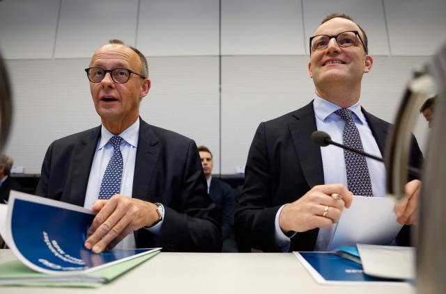 (FILES) German Chancellor and leader of Germany's Christian Democratic Union (CDU) Friedrich Merz (L) and the parliamentary group leader of the conservative Christian Democratic Union (CDU) Jens Spahn sit side by side at the start of a parliamentary group meeting of the conservative party union on December 2, 2025 in Berlin, Germany. Jens Spahn, a prominent figure in German Chancellor Friedrich Merz's centre-right party resigned his leadership post on July 18, 2026, party sources told AFP, amid controversy over his use of a surrogate mother in the US despite a ban on the practice in Germany. "In recent days, I have come to realise that my personal happiness in starting a family with my husband and becoming a father is incompatible with my political office," Jens Spahn, the chairman of the CDU's faction in parliament, wrote in a letter to colleagues that was obtained by AFP. (Photo by Odd ANDERSEN / AFP)