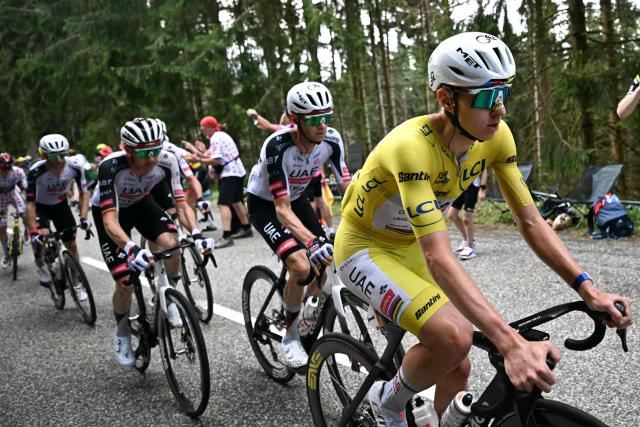 UAE Team Emirates - XRG's Slovenian rider Tadej Pogacar wearing the overall leader's yellow jersey cycles with his teammates in the Grand Ballon ascent during the 14th stage of the 113th edition of the Tour de France cycling race, 155,3 km between Mulhouse and Le Markstein in the Vosges mountains, on July 18, 2026. (Photo by Loic VENANCE / AFP)