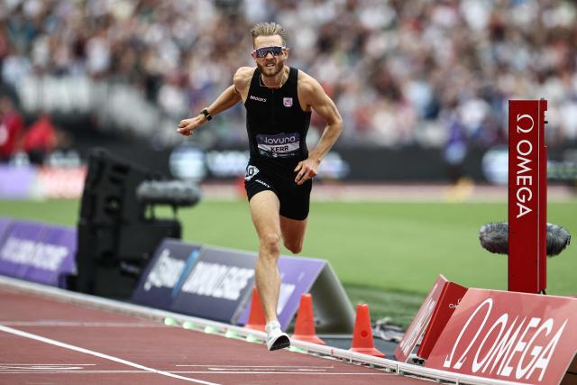 Britain's Josh Kerr crosses the finish line to win the men's one mile event during the IAAF Diamond League athletics competition at the London stadium in London on July 18, 2026. (Photo by Henry NICHOLLS / AFP)