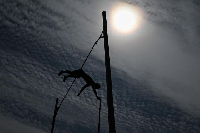 Norway's Sondre Guttormsen is silhouetted as he competes in the men's pole vault event during the IAAF Diamond League athletics competition at the London stadium in London on July 18, 2026. (Photo by Glyn KIRK / AFP)