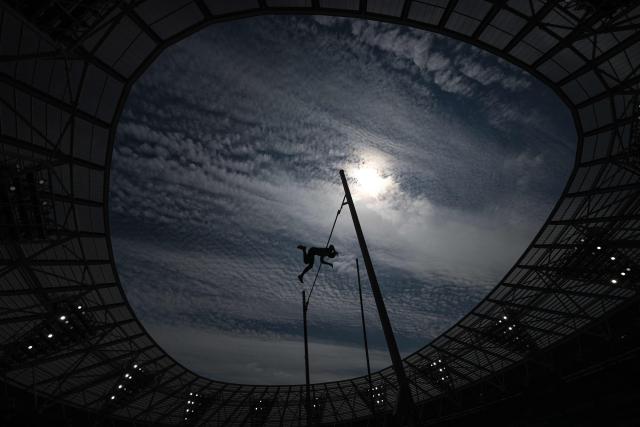 Greece's Emmanouil Karalis is silhouetted as he competes in the men's pole vault event during the IAAF Diamond League athletics competition at the London stadium in London on July 18, 2026. (Photo by Glyn KIRK / AFP)