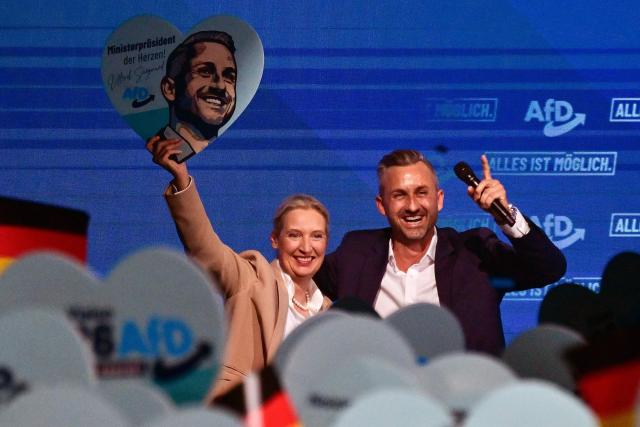 Alice Weidel (L), co-leader of the far-right Alternative for Germany (AfD) party, and  Ulrich Siegmund, AfD top candidate for Saxony-Anhalt are cheered by supportes during an election campaign event ahead of the state elections in Saxony-Anhalt, in Magdeburg, eastern Germany on July 18, 2026. Slogan reads "Everything is possible". The crucial state election in the German eastern federal state of Saxony-Anhalt is scheduled to take place on September 6, 2026. (Photo by John MACDOUGALL / AFP)