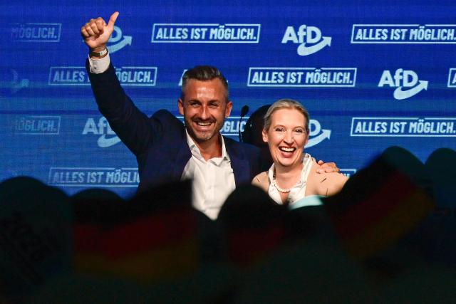 Alice Weidel (R), co-leader of the far-right Alternative for Germany (AfD) party, and  Ulrich Siegmund, AfD top candidate for Saxony-Anhalt are cheered by supportes during an election campaign event ahead of the state elections in Saxony-Anhalt, in Magdeburg, eastern Germany on July 18, 2026. Slogan reads "Everything is possible". The crucial state election in the German eastern federal state of Saxony-Anhalt is scheduled to take place on September 6, 2026. (Photo by John MACDOUGALL / AFP)