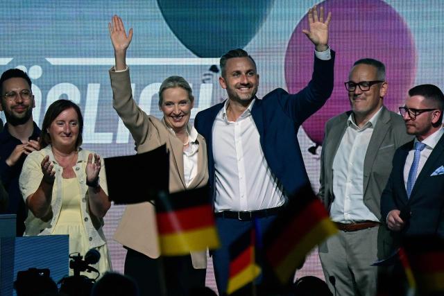 Alice Weidel (C, L), co-leader of the far-right Alternative for Germany (AfD) party, and Ulrich Siegmund (C, R), AfD top candidate for Saxony-Anhalt wave to supportes on stage togehter with other members of the party leadership at the end of an election campaign event ahead of the state elections in Saxony-Anhalt, in Magdeburg, eastern Germany on July 18, 2026. Slogan reads "Everything is possible". The crucial state election in the German eastern federal state of Saxony-Anhalt is scheduled to take place on September 6, 2026. (Photo by John MACDOUGALL / AFP)