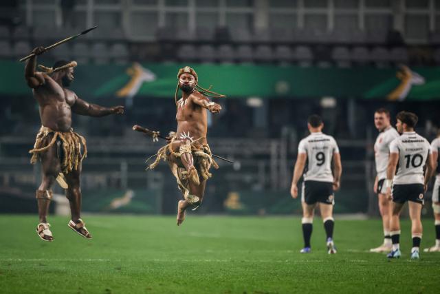Members of the Springbok Impi Warriors perform as Wales players take to the pitch ahead of the rugby Nations Championship match between South Africa and Wales at Kings Park Stadium in Durban on July 18, 2026. (Photo by PHILL MAGAKOE / AFP)