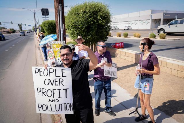 Demonstrators wave signs during a nationwide protest against AI data center expansion in Imperial, California on July 18, 2026. (Photo by SANDY HUFFAKER / AFP)