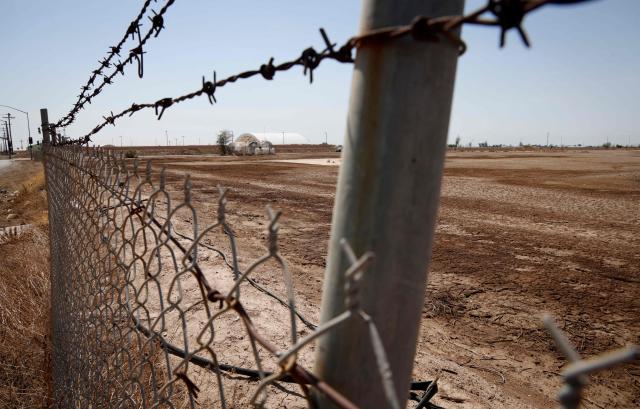 A chain link fence surrounds a proposed site where a new Data Center facility would be built in El Centro, California on July 18, 2026. (Photo by SANDY HUFFAKER / AFP)