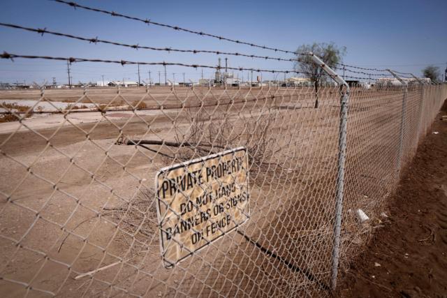 A chain link fence surrounds a proposed site where a new Data Center facility would be built in El Centro, California on July 18, 2026. (Photo by SANDY HUFFAKER / AFP)