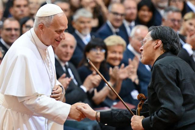 Pope Leo XIV greets the Italian violinist Marco Rogliano as he attend a concert in the Apostolic Palace at the summer papal residence in Castel Gandolfo on July 18, 2026. (Photo by Alberto PIZZOLI / AFP)