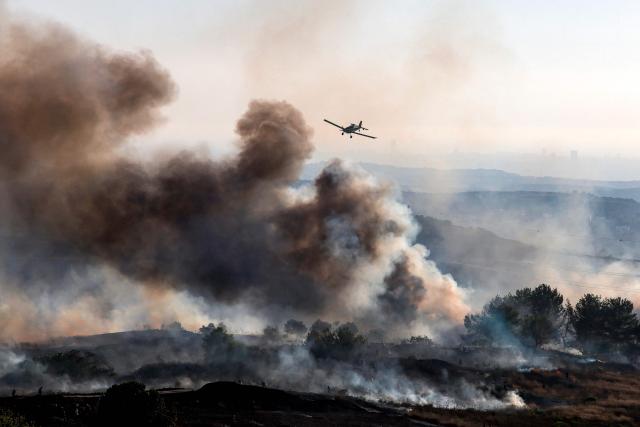 An Israeli Air Tractor AT-802 firefighting plane extinguishes a blaze near the village of Tell, adjacent to the Israeli settlement of Havat Gilad, west of Nablus in the occupied West Bank on July 18, 2026, after a reported arson attack by Israeli settlers on the village, according to eyewitnesses. (Photo by Jaafar ASHTIYEH / AFP)