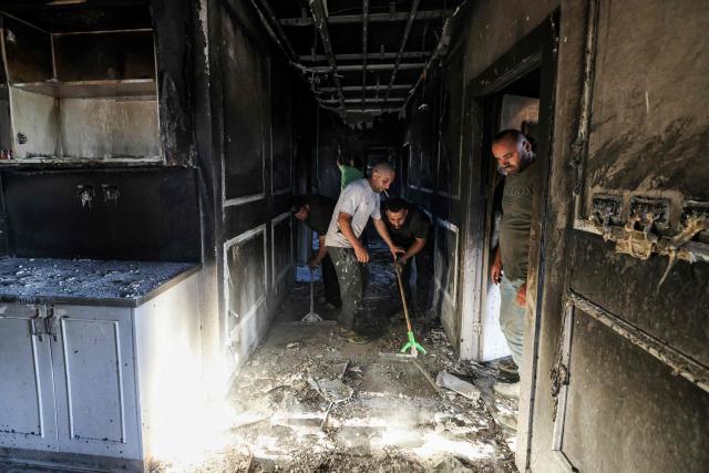 Palestinians inspect damages at a building that was reportedly according to eyewitnesses set on fire by Israeli settlers in the village of Tell, adjacent to the Israeli settlement of Havat Gilad, west of Nablus in the occupied West Bank on July 18, 2026. (Photo by JAAFAR ASHTIYEH / AFP)