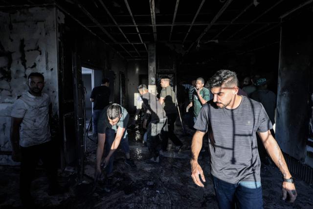 Palestinians inspect damages at a building that was reportedly according to eyewitnesses set on fire by Israeli settlers in the village of Tell, adjacent to the Israeli settlement of Havat Gilad, west of Nablus in the occupied West Bank on July 18, 2026. (Photo by JAAFAR ASHTIYEH / AFP)