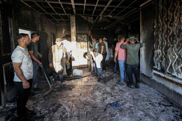 Palestinians inspect damages at a building that was reportedly according to eyewitnesses set on fire by Israeli settlers in the village of Tell, adjacent to the Israeli settlement of Havat Gilad, west of Nablus in the occupied West Bank on July 18, 2026. (Photo by JAAFAR ASHTIYEH / AFP)