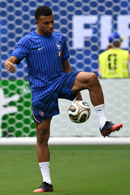 France's forward #10 Kylian Mbappe warms up ahead of the 2026 World Cup football tournament third-place match between France and England at the Miami Stadium in Miami on July 18, 2026.  (Photo by ROBERTO SCHMIDT / AFP)