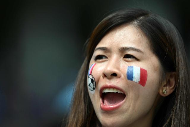 A French fan cheers for her team ahead of the 2026 World Cup football tournament third-place match between France and England at the Miami Stadium in Miami on July 18, 2026.  (Photo by ROBERTO SCHMIDT / AFP)