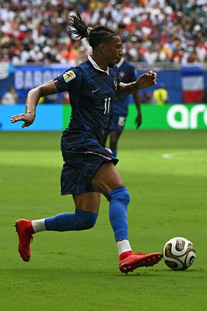 France's forward #11 Michael Olise controls the ball during the 2026 World Cup football tournament third-place match between France and England at the Miami Stadium in Miami on July 18, 2026.  (Photo by ROBERTO SCHMIDT / AFP)