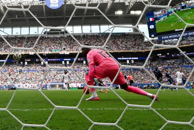 France's goalkeeper #16 Mike Maignan concedes a goal scored by England's midfielder #04 Declan Rice his team's first goal during the 2026 World Cup football tournament third-place match between France and England at the Miami Stadium in Miami on July 18, 2026.  (Photo by CHANDAN KHANNA / AFP)