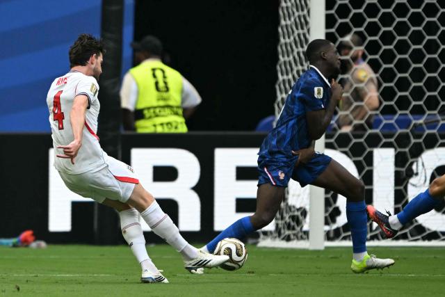 England's midfielder #04 Declan Rice scores his team's first goal during the 2026 World Cup football tournament third-place match between France and England at the Miami Stadium in Miami on July 18, 2026.  (Photo by ROBERTO SCHMIDT / AFP)