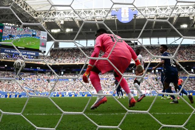England's defender #02 Ezri Konsa heads the ball and scores his team's second goal during the 2026 World Cup football tournament third-place match between France and England at the Miami Stadium in Miami on July 18, 2026.  (Photo by CHANDAN KHANNA / AFP)