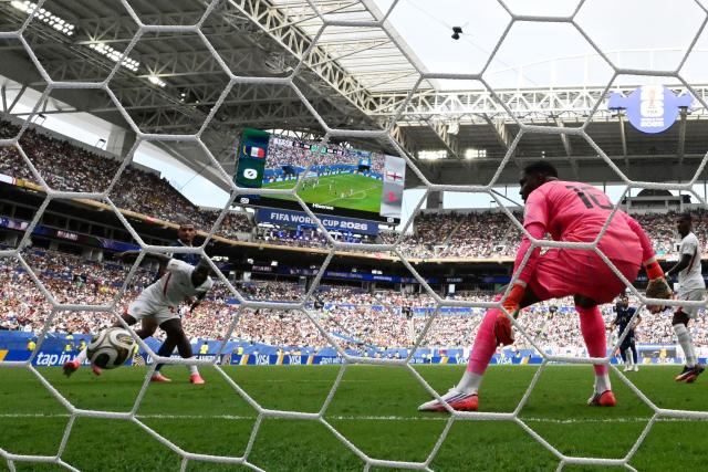 England's defender #02 Ezri Konsa heads the ball and scores his team's second goal during the 2026 World Cup football tournament third-place match between France and England at the Miami Stadium in Miami on July 18, 2026.  (Photo by CHANDAN KHANNA / AFP)