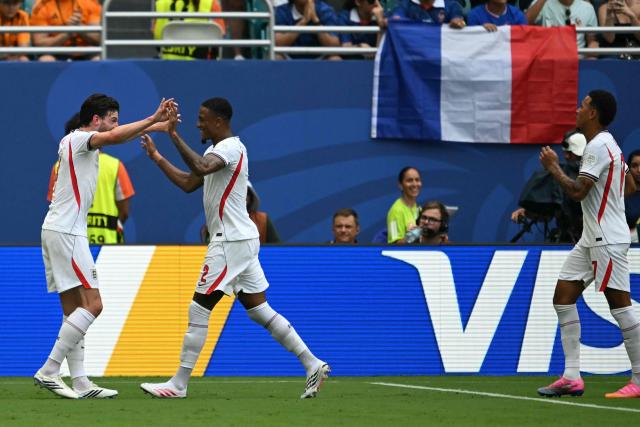England's defender #02 Ezri Konsa (C) celebrates scoring his team's second goal with midfielder #04 Declan Rice (L) during the 2026 World Cup football tournament third-place match between France and England at the Miami Stadium in Miami on July 18, 2026.  (Photo by ROBERTO SCHMIDT / AFP)