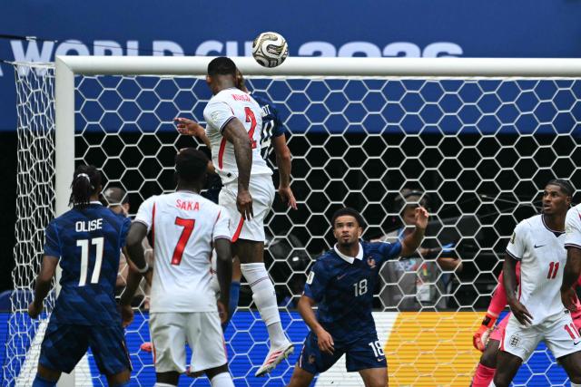 England's defender #02 Ezri Konsa heads the ball and scores his team's second goal during the 2026 World Cup football tournament third-place match between France and England at the Miami Stadium in Miami on July 18, 2026.  (Photo by ROBERTO SCHMIDT / AFP)