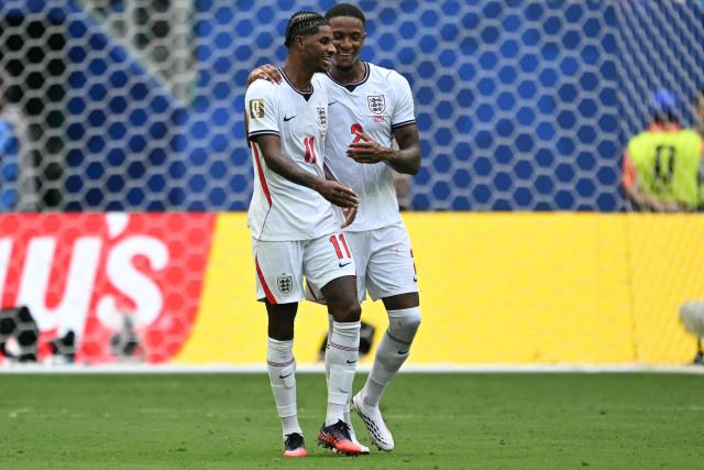 England's forward #11 Marcus Rashford and defender #02 Ezri Konsa celebrate their team's third goal scored by forward #07 Bukayo Saka (unseen) during the 2026 World Cup football tournament third-place match between France and England at the Miami Stadium in Miami on July 18, 2026.  (Photo by ROBERTO SCHMIDT / AFP)