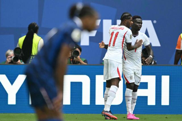 England's forward #07 Bukayo Saka celebrates scoring his team's fourth goal with teammate forward #11 Marcus Rashford during the 2026 World Cup football tournament third-place match between France and England at the Miami Stadium in Miami on July 18, 2026.  (Photo by ROBERTO SCHMIDT / AFP)