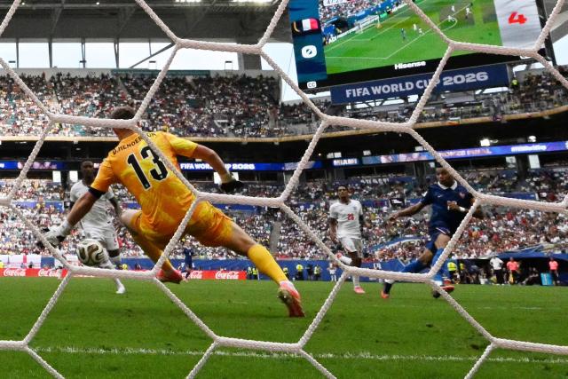 England's goalkeeper #13 Dean Henderson concedes a goal scored by France's forward #10 Kylian Mbappe and his team's first goal during the 2026 World Cup football tournament third-place match between France and England at the Miami Stadium in Miami on July 18, 2026.  (Photo by CHANDAN KHANNA / AFP)