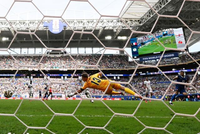 England's goalkeeper #13 Dean Henderson concedes a goal scored by France's forward #10 Kylian Mbappe and his team's first goal during the 2026 World Cup football tournament third-place match between France and England at the Miami Stadium in Miami on July 18, 2026.  (Photo by CHANDAN KHANNA / AFP)