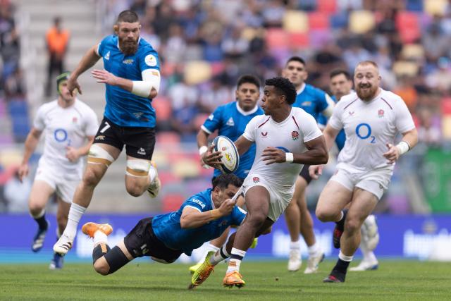 England's wing Immanuel Feyi-Waboso (R) is tackled by Argentina's centre Matias Moroni during the Rugby Union Nations Championship match between Argentina and England at Unico Madre de Ciudades stadium in Santiago del Estero, Argentina, on July 18, 2026. Argentina players wear a blue jersey as a tribute to the Argentina national football team that defeated England with goals by Diego Maradona at the Mexico 1986 World Cup. (Photo by Juan GASPARINI / AFP)
