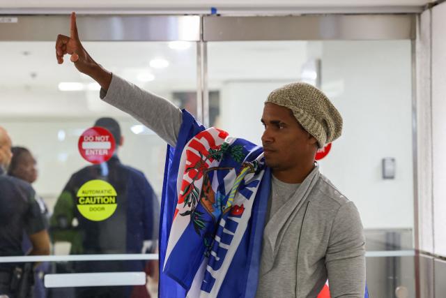 Luis Manuel Otero Alcántara, artist and opponent of the Cuban regime, gestures upon his arrival at Miami International Airport on July 18, 2026. Prominent Cuban dissident artist Luis Manuel Otero Alcantara flew to exile Saturday in the United States after serving a five-year sentence on the island, as Washington urged Havana to release more than 700 political prisoners. (Photo by Giorgio VIERA / AFP)