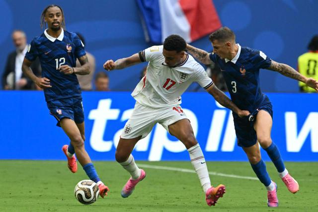 England's midfielder #17 Morgan Rogers and France's defender #03 Lucas Digne fight for the ball during the 2026 World Cup football tournament third-place match between France and England at the Miami Stadium in Miami on July 18, 2026.  (Photo by ROBERTO SCHMIDT / AFP)
