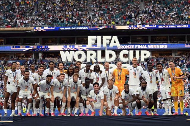 England's players pose for a photo with their medals after winning the 2026 World Cup football tournament third-place match between France and England at the Miami Stadium in Miami on July 18, 2026.  (Photo by ROBERTO SCHMIDT / AFP)