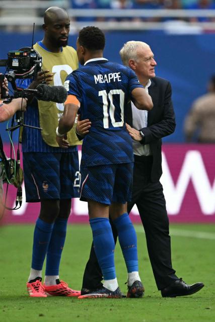 France's head coach Didier Deschamps and forward #10 Kylian Mbappe hug after losing the 2026 World Cup football tournament third-place match between France and England at the Miami Stadium in Miami on July 18, 2026.  (Photo by ROBERTO SCHMIDT / AFP)