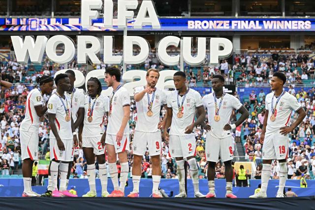 England's players pose for a photo with their medals after winning the 2026 World Cup football tournament third-place match between France and England at the Miami Stadium in Miami on July 18, 2026.  (Photo by ROBERTO SCHMIDT / AFP)