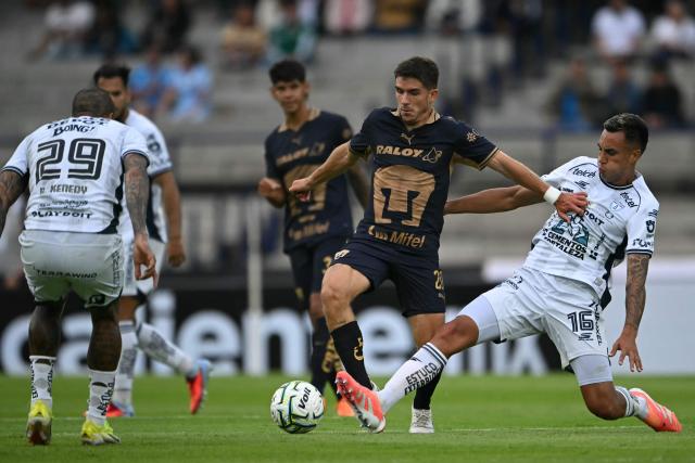 Pumas' midfielder #20 Santiago Trigos (C) and Pachuca's Colombian midfielder #16 Christian Rivera fight for the ball during the Liga MX Apertura football match between Pumas and Pachuca at Olimpico Universitario stadium in Mexico City on July 18, 2026. (Photo by CARL DE SOUZA / AFP)
