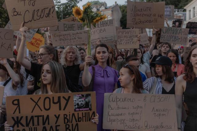 Protesters hold placards and chant slogans during a demonstration against Ukraine's President's decision to dismiss Ukraine's Defence Minister Mykhailo Fedorov, and demanding the dismissal of Ukraine's army chief Oleksandr Syrskyi, in Kyiv on July 18, 2026, amid the Russian invasion of Ukraine. Large protests erupted in several Ukrainian cities against the removal of popular Defence Minister Fedorov, who had been brought in six months ago to digitise and modernise an army fatigued after four years fighting off the Russian invasion. (Photo by Roman PILIPEY / AFP)