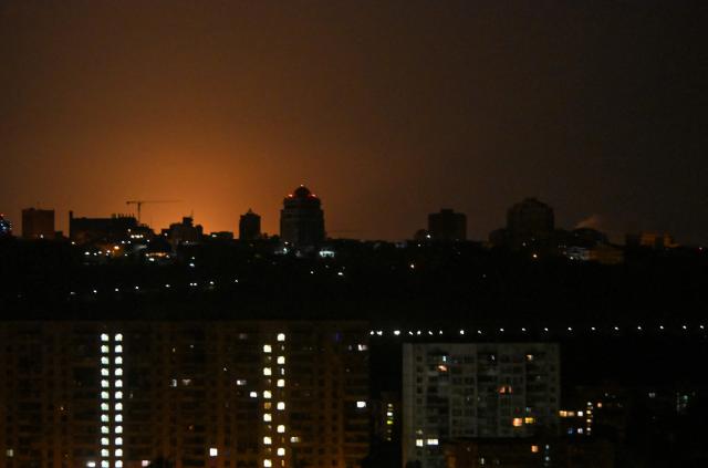 This photograph shows glow during Russian missile strikes on the Ukrainian capital of Kyiv on July 19, 2026, amid the Russian invasion in Ukraine. Russian missiles rocked Ukraine's capital overnight, damaging residential buildings and wounding at least two people a day after Kyiv launched a wave of drone strikes deep into Russian territory. (Photo by Eugene KOTENKO / AFP)