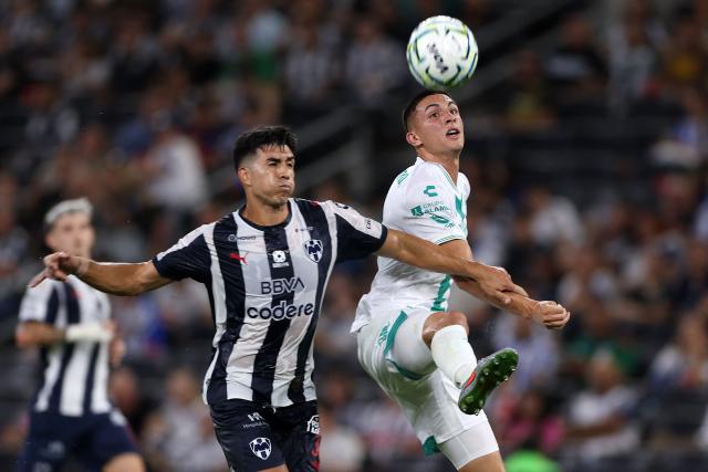 Monterrey's Colombian defender #33 Stefan Medina and Santos' Argentine forward #09 Lucas di Yorio fight for the ball during the Liga MX Apertura football match between Monterrey and Santos Laguna at BBVA stadium in Guadalupe, Nuevo Leon state, Mexico on July 18, 2026. (Photo by Julio Cesar AGUILAR / AFP)