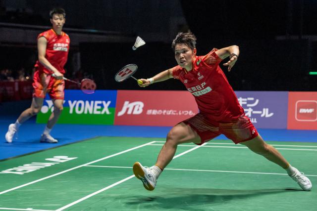 China’s Huang Dongping (R) and Feng Yanzhe hit a return against Hong Kong's Tang Chun Man and Tse Ying Suet in their mixed doubles final match of the Japan Open badminton tournament at Tokyo Gymnasium in Tokyo on July 19, 2026. (Photo by Yuichi YAMAZAKI / AFP)