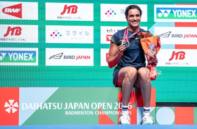 Gold medalist India’s Pusarla Venkata Sindhu poses on the podium after her victory against Japan’s Akane Yamaguchi in their women's singles final match of the Japan Open badminton tournament at Tokyo Gymnasium in Tokyo on July 19, 2026. (Photo by Yuichi YAMAZAKI / AFP)