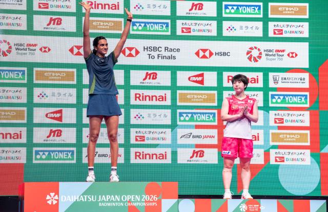 Gold medalist India’s Pusarla Venkata Sindhu (L) celebrates on the podium after her victory against Japan’s Akane Yamaguchi in their women's singles final match of the Japan Open badminton tournament at Tokyo Gymnasium in Tokyo on July 19, 2026. (Photo by Yuichi YAMAZAKI / AFP)