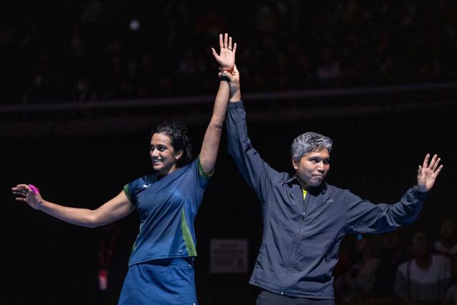 India’s Pusarla Venkata Sindhu (L) and her coach celebrate the victory against Japan’s Akane Yamaguchi in their women's singles final match of the Japan Open badminton tournament at Tokyo Gymnasium in Tokyo on July 19, 2026. (Photo by Yuichi YAMAZAKI / AFP)