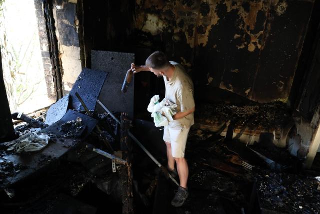 A local resident examines his flat in a residential building following a Russian missile strikes in Kyiv on July 19, 2026, amid the Russian invasion of Ukraine. Russian missiles rocked Ukraine's capital overnight, damaging residential buildings and wounding at least two people a day after Kyiv launched a wave of drone strikes deep into Russian territory. (Photo by Serhii Okunev / AFP)