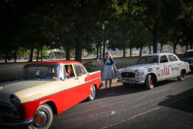 Participants take part in the 19th Summer parade of vintage vehicles in Paris on July 19, 2026. (Photo by Lou BENOIST / AFP)