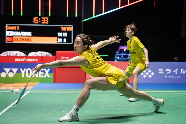 China’s Jia Yifan and Zhang Shuxian play a point against South Korea’s Kim Hye-jeong and Kong Hee-yong during the women's doubles final of the Japan Open badminton tournament at Tokyo Gymnasium in Tokyo on July 19, 2026. (Photo by Yuichi YAMAZAKI / AFP)